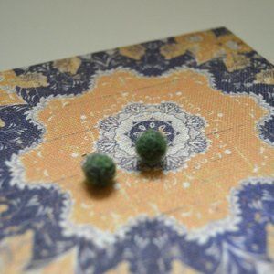 Green ball-shaped felted studs